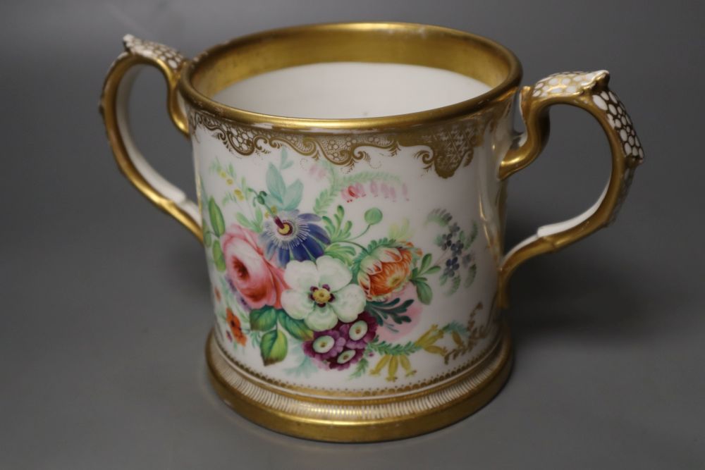An English porcelain two handled mug lavishly painted with flowers, inscribed verso William Brown 1854, 14cm